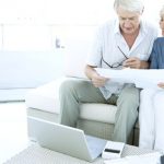 Retired senior couple doing home finance with paperwork, laptop and calculator