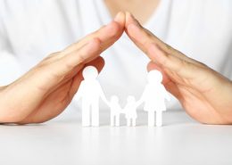 Figurine of family in male hands, closeup