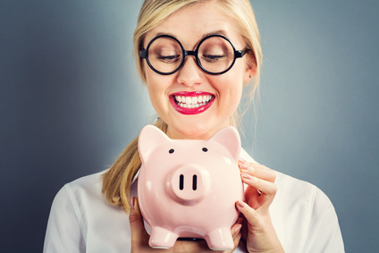 Young blonde woman with a piggy bank