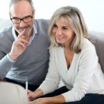 Senior couple meeting financial adviser for investment